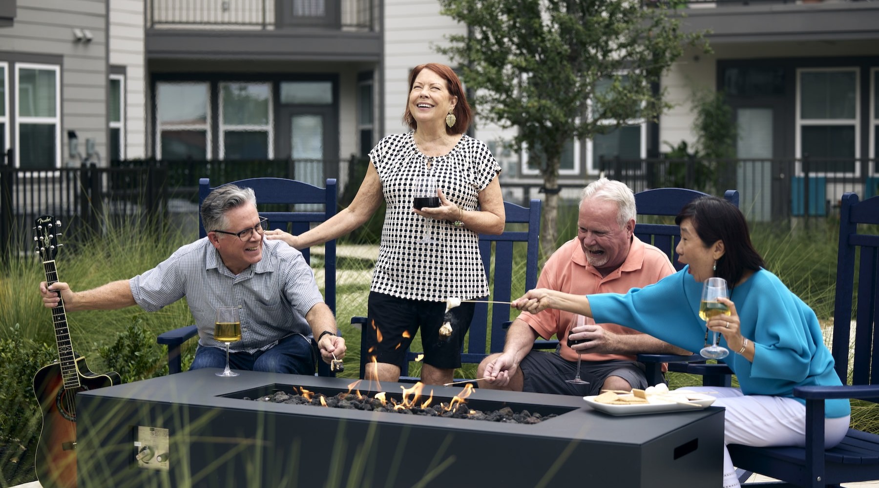 Love where you live a group of people laughing around a fire