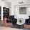 a room with a table chairs and a shelf with books