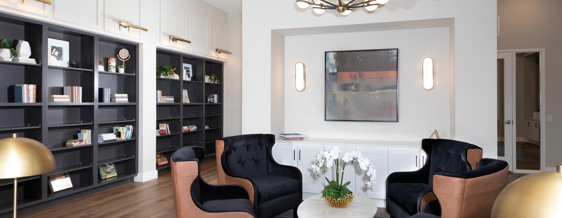 a room with a table chairs and a shelf with books