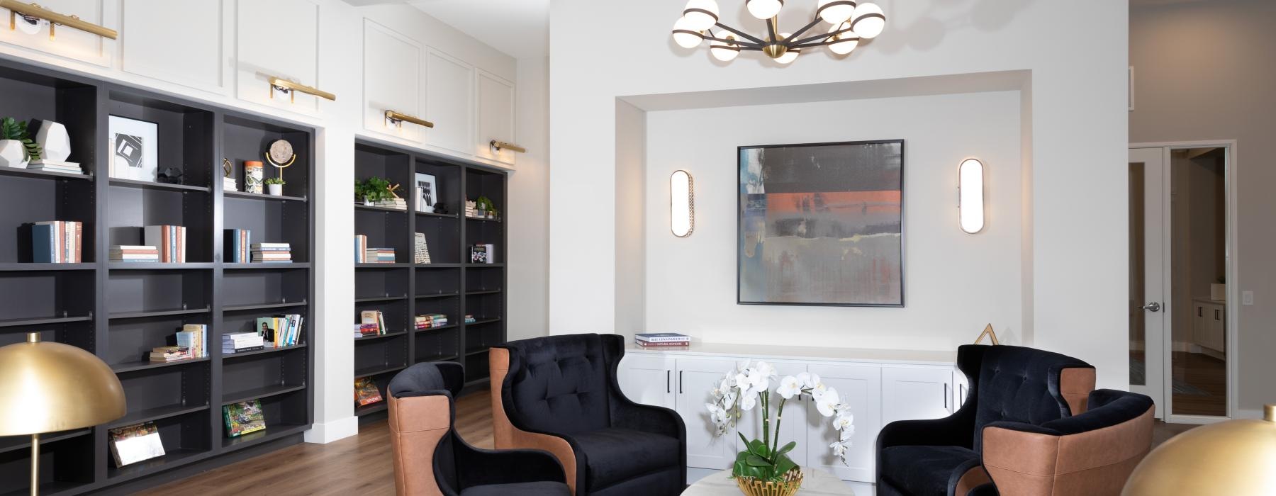 a room with a table chairs and a shelf with books
